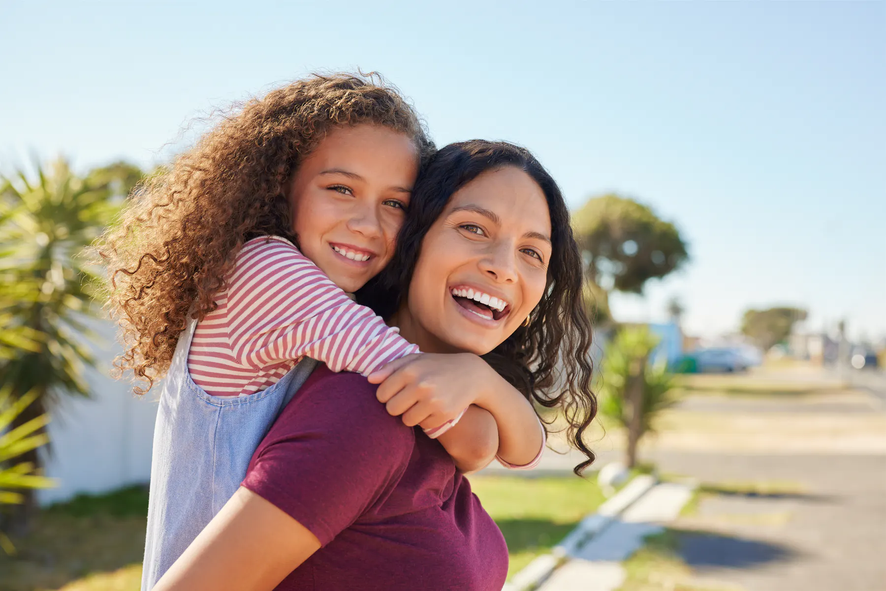 Parent and child smiling together outdoors