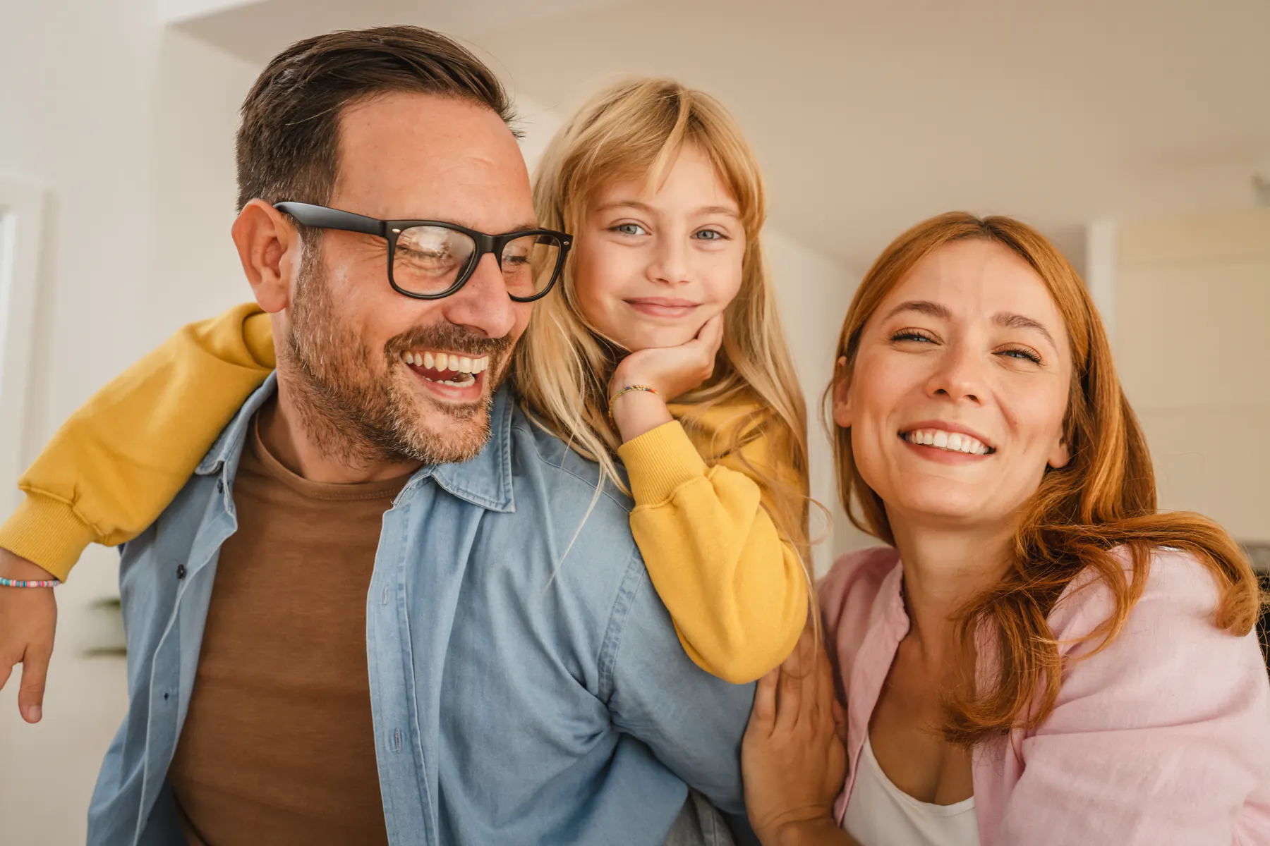Parents and child smiling together